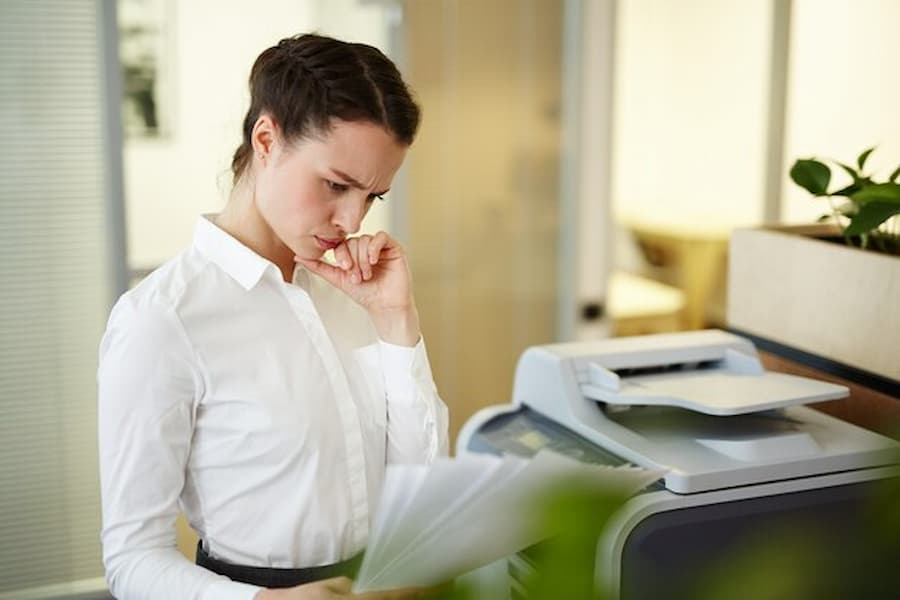 Woman is reading Types and Features of Copiers to choose best one