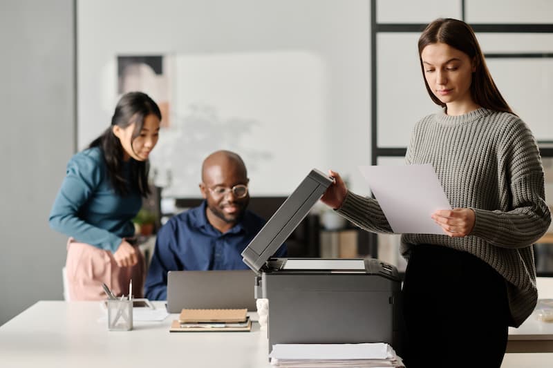 A Woman is printing document in office